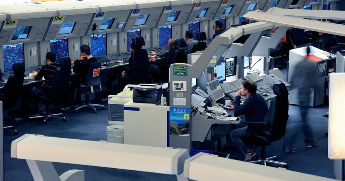EUROCONTROL operations room with multiple air traffic controllers working at radar stations