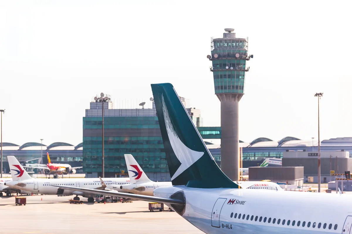 Aircraft on the Hong Kong International Airport apron with the control tower in the background