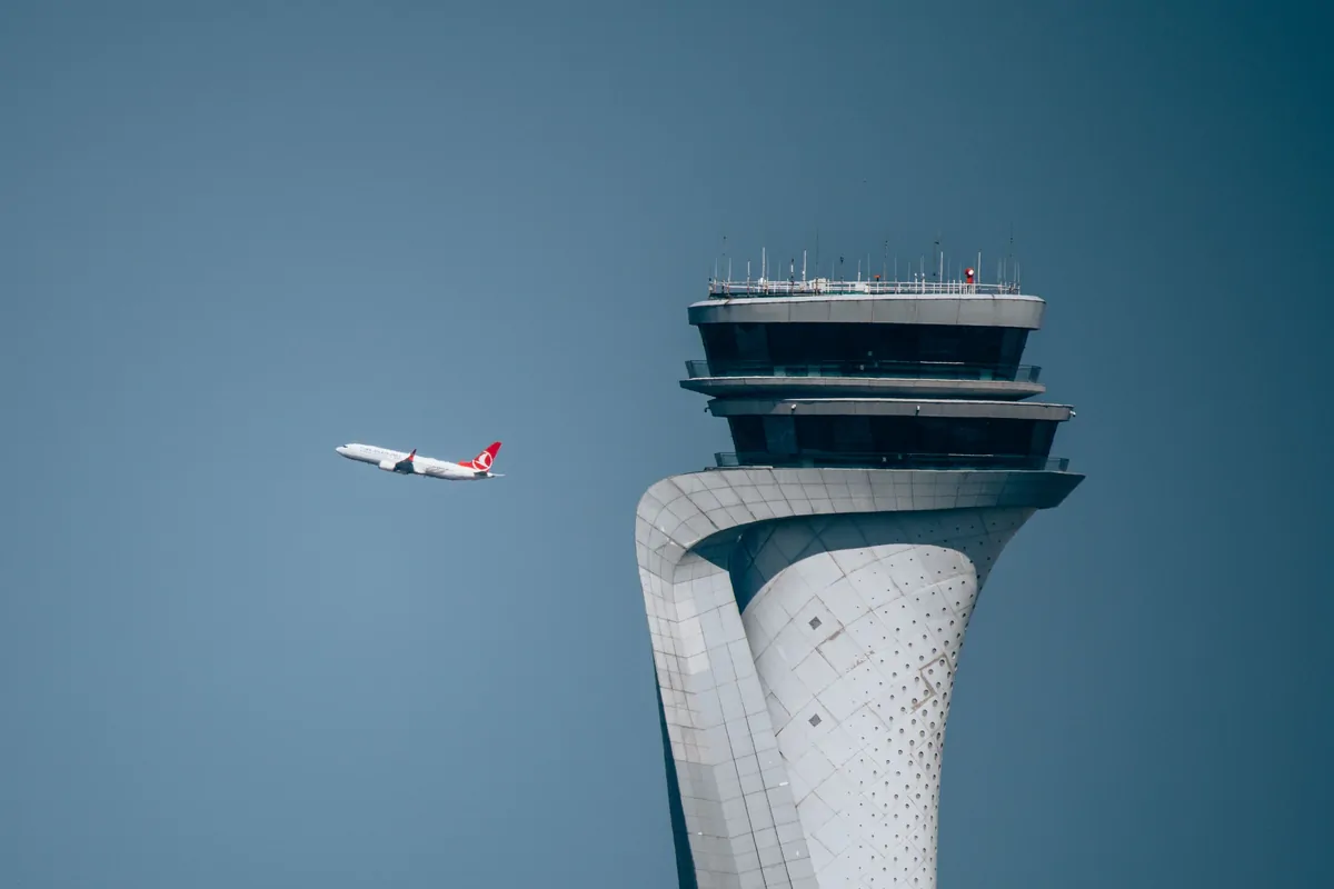 Aircraft departing past the Istanbul Airport air traffic control tower